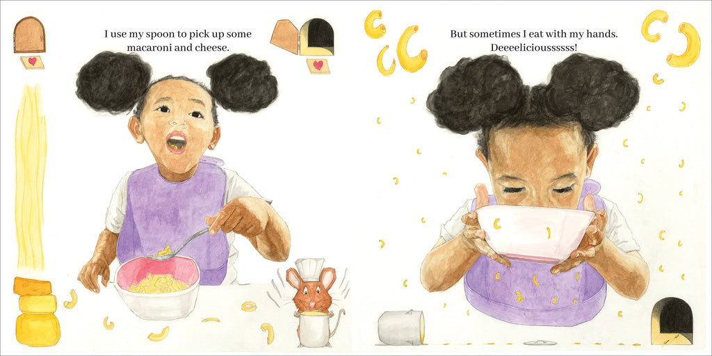  There are two images. In the first, Feven uses a spoon to scoop macaroni and cheese. In the top corners are tiny doors with a doormat, one closed and the other open. In the bottom right, a mouse in a chef’s hat holds a cooking pot, surrounded by scattered macaroni. In the second, Feven lifts the bowl to her mouth. Macaroni of different sizes frame the page. In the bottom left, a tiny cooking pot tips over, leaving prints leading to a mouse hole. Text states she sometimes eats with her hands. 