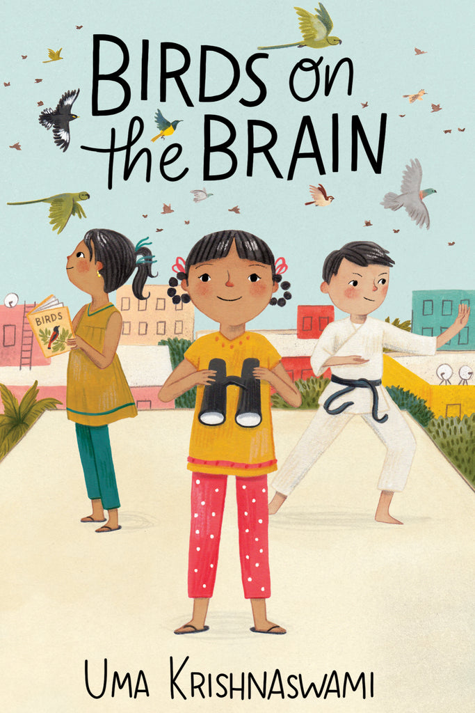  Cover: Birds on the Brain. By Uma Krishnaswami. Three kids stand on an apartment building rooftop. The girl on the left has medium-dark skin tone, wears her black hair in pigtails and holds a book called 
