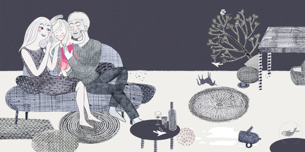  This image is in shades of black and white. A space inside of a home has many small circular rugs, a table, and a small couch. On the couch are a man, a woman, and a girl who is wearing a pink tutu. The man and the woman hold the girl between them in a hug. Small knick-knacks and décor are on the floor along with a teapot and spilt liquid. 