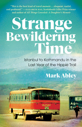 Cover: Strange Bewildering Time: Istanbl to Kathmandu in the Last Year of the Hippie Trail by Mark Abley. A vintage colour photograph of a red-orange 1960s bus on a deserted road. Beside the bus is one half of a road sign, with a dark-skinned man standing in front of it. In the background are rolling green hills and a white-tipped mountain, with a blue-green sky above. 