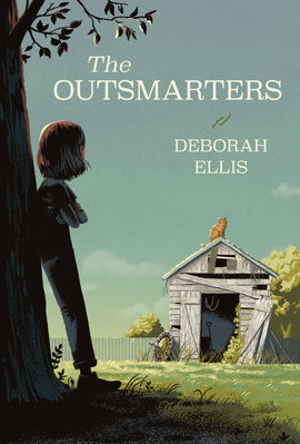  Cover: The Outsmarters, by Deborah Ellis. A young girl leans against a tree trunk, looking back at a shed in a yard full of sunlit grass. She has light skin tone and chin-length hair, and she and the tree are shadowed in the foreground. Across the yard, an orange cat sits on top of the worn shed and returns her gaze. A roulette wheel is propped against the falling-apart shed wall. A fence lines the background, with trees behind it against a light blue sky. 