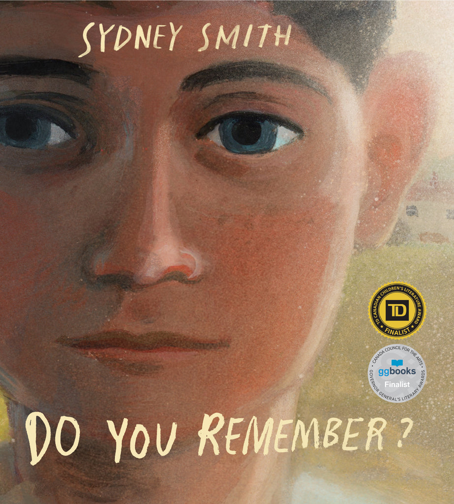  Do You Remember? by Sydney Smith. There is a close-up watercolor illustration of the face of a blue-eyed boy with a medium-light skin tone and short curly brown hair. He looks out into the distance. 
