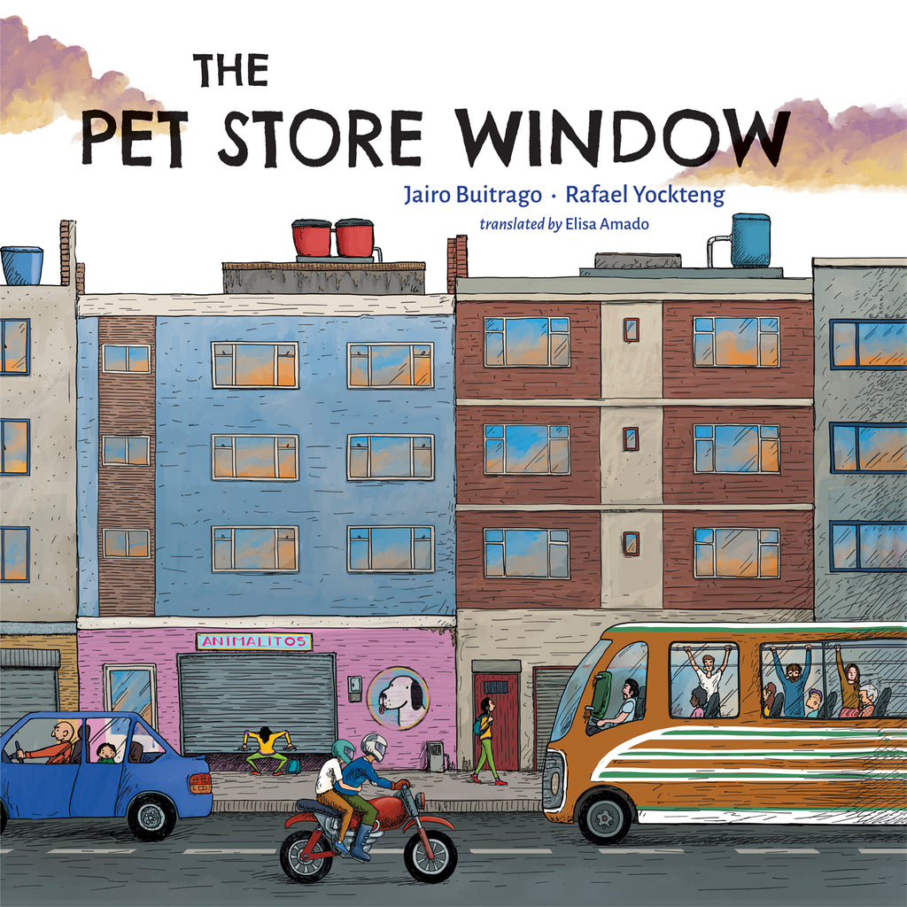  The Pet Store Window. Written by Jairo Buitrago and illustrated by Rafael Yockteng. A street view of a city. One of the buildings has an image of a dog on the bottom floor. 