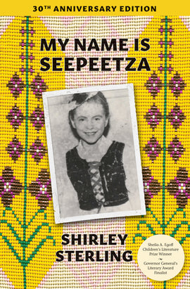  My Name Is Seepeetza by Shirley Sterling. This image features beadwork by Speplól Tanya Zilinski. A tattered and worn black-and-white photograph is in the middle of the image. In the photograph is a girl with light skin tone and brown hair pulled back. She wears a white shirt with a black vest on top. She smiles at the camera. Behind this photograph is a background of small colored beads that form a tapestry.  The section behind the photograph is light pink and creamy white in a geometric pattern. 